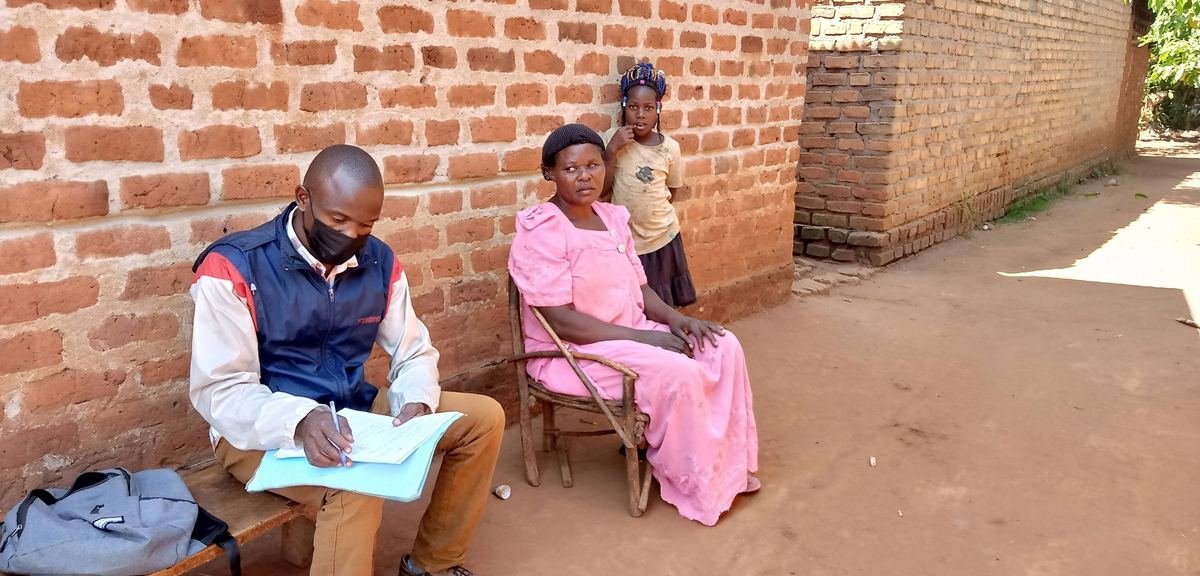 A counsellor speaking with a community member outdoors